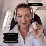 Woman holding Stress Test Daily Repair Spray travel size on flight. Hydrating formula with bakuchiol and aloe to smooth uneven skin texture