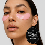 Woman wearing pink eye masks with 'The Beauty Awards' logo on a white background